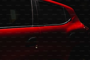 a close up of a red car in the dark