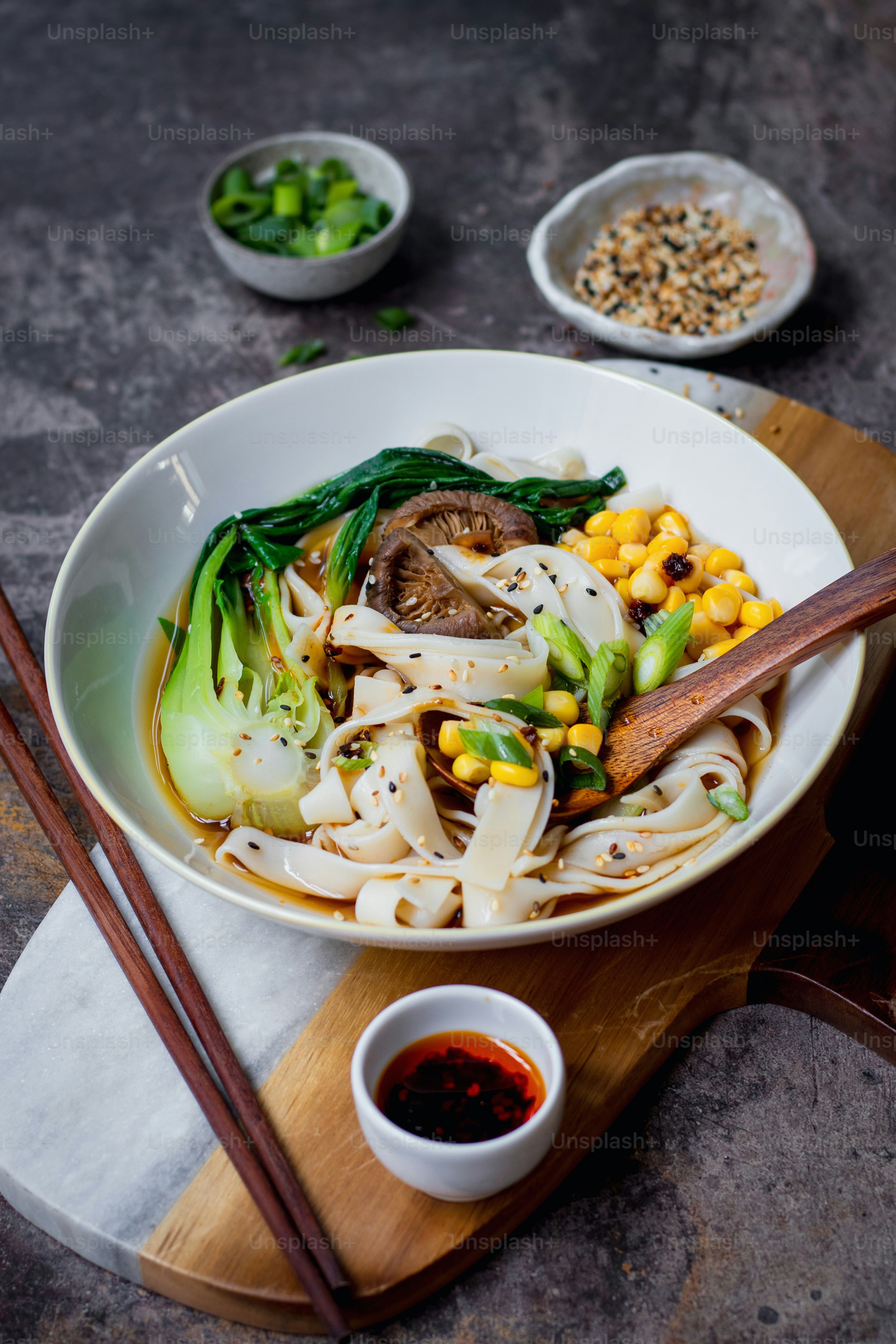 a white bowl filled with noodles and vegetables