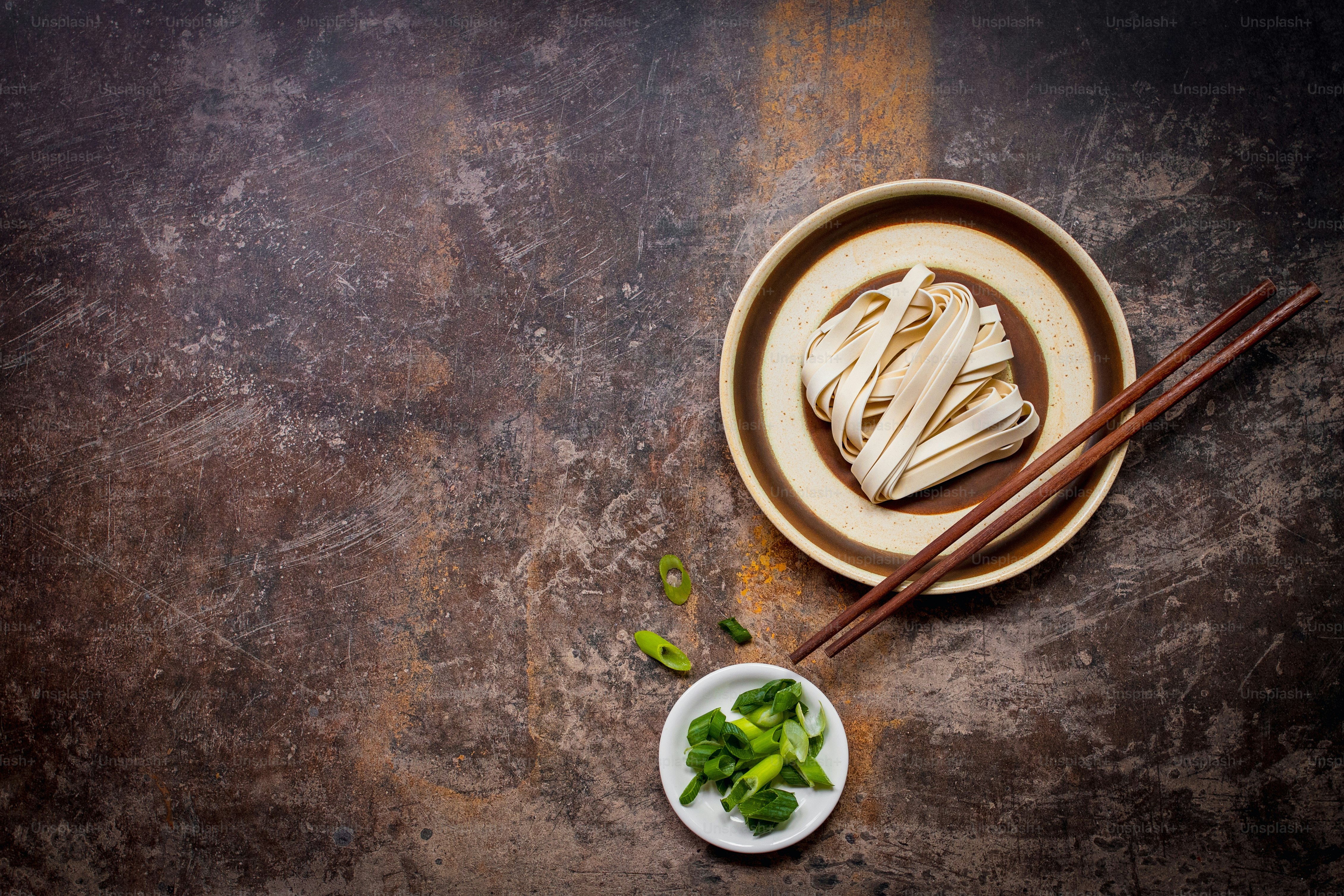 Ramen noodles on plates with chopsticks.