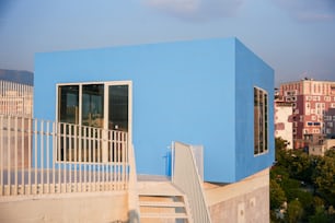 a blue building with stairs leading up to it