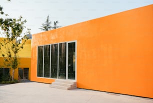 a large orange building with a white door and windows