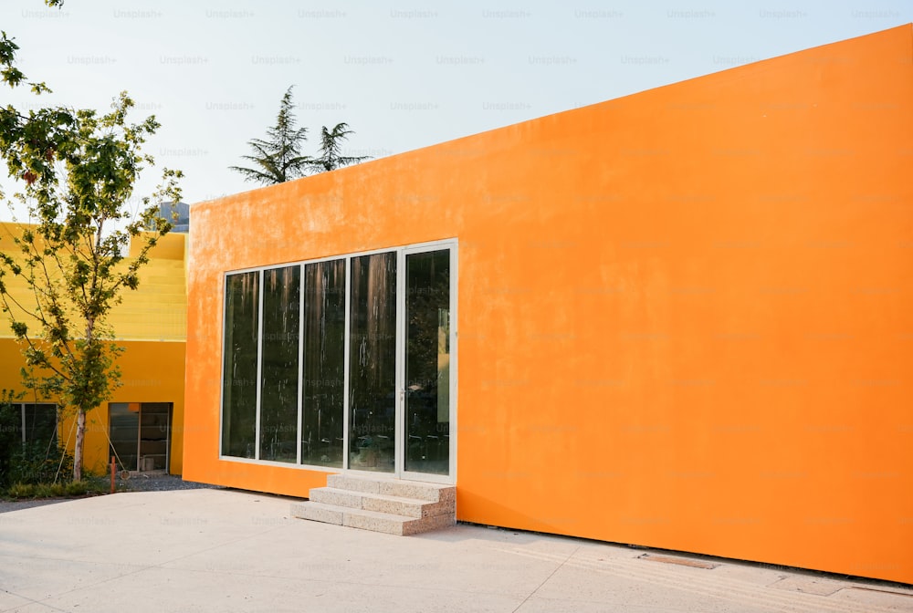 a large orange building with a white door and windows