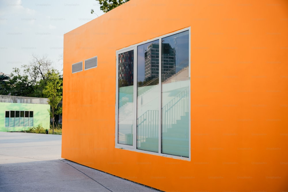 a large orange building with a large window