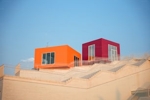 a couple of orange and red buildings sitting on top of a building