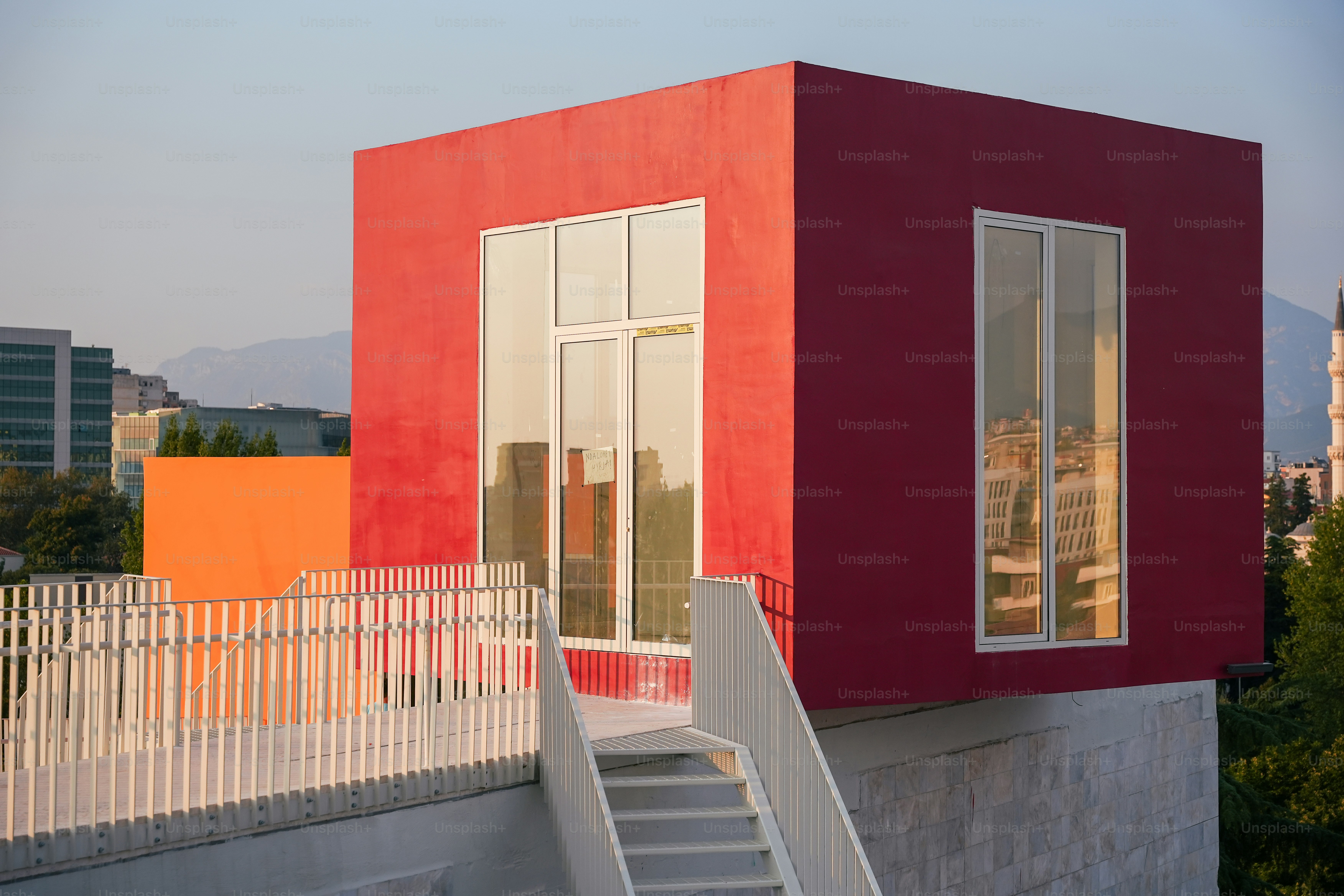 a red building with a white staircase leading up to it