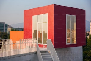 a red building with a white staircase leading up to it