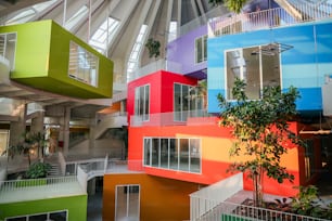 a multicolored building with a tree inside of it