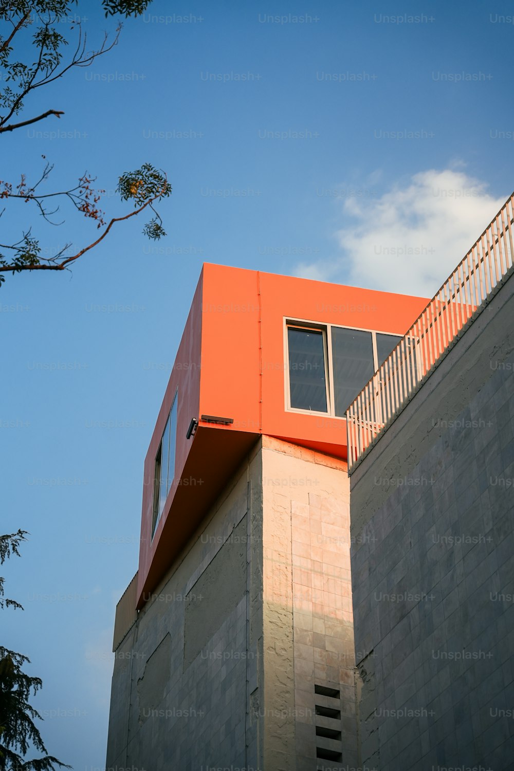 a tall building with a red roof and a balcony