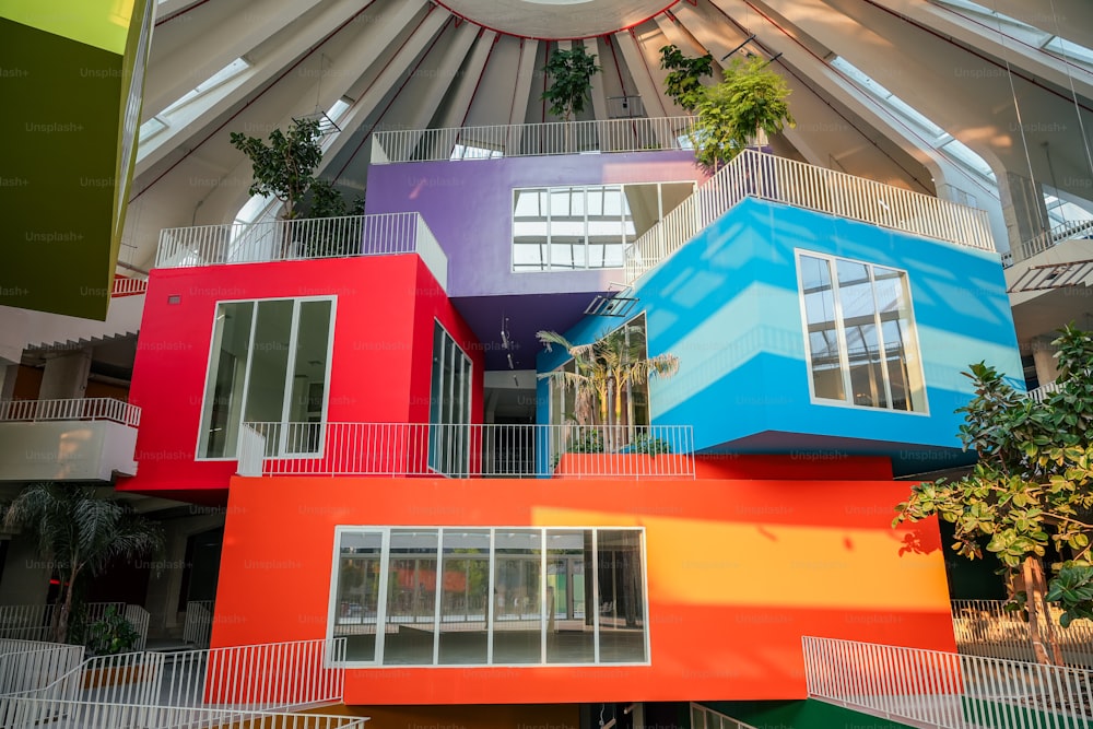 a multicolored building with a skylight in the background