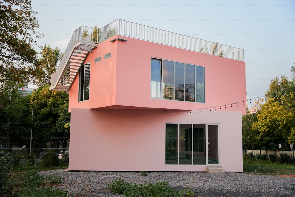 a pink house with a staircase going up the side of it