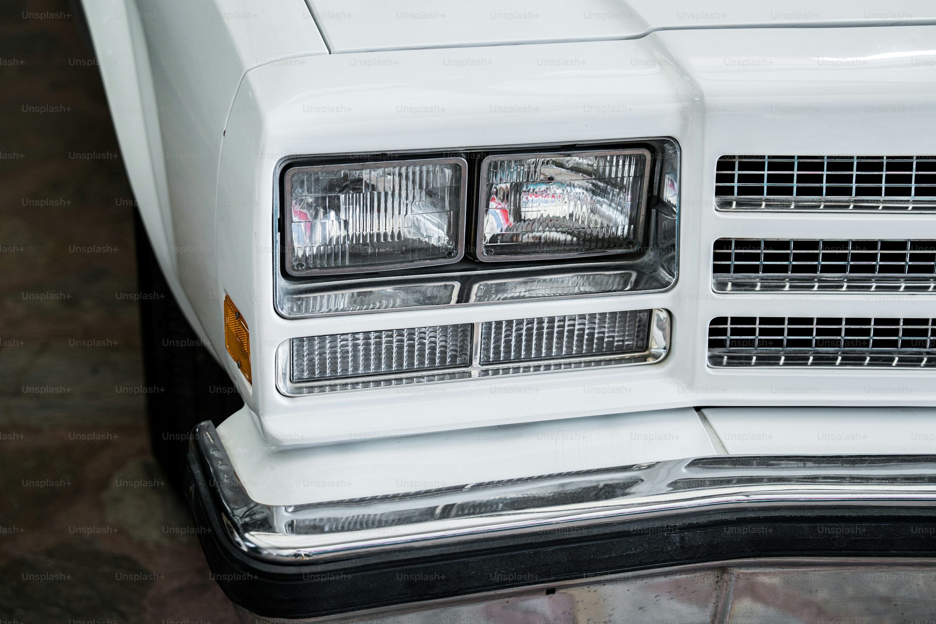 a close up of the front of a white car