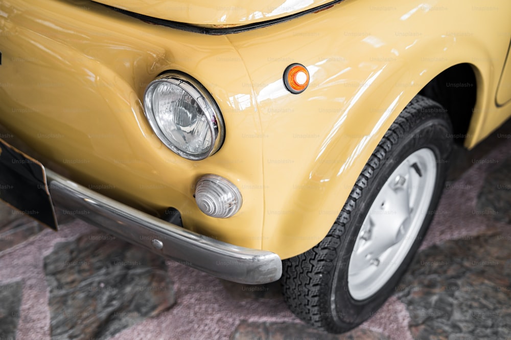 a close up of the front of a yellow car