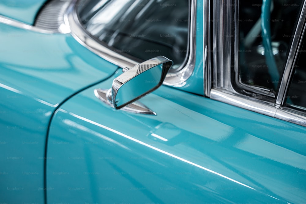 a close up of a blue car door handle