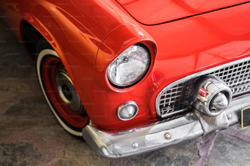 a close up of the front end of a red car