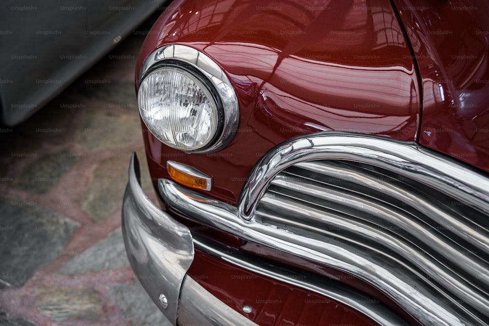 a close up of the front end of a classic car