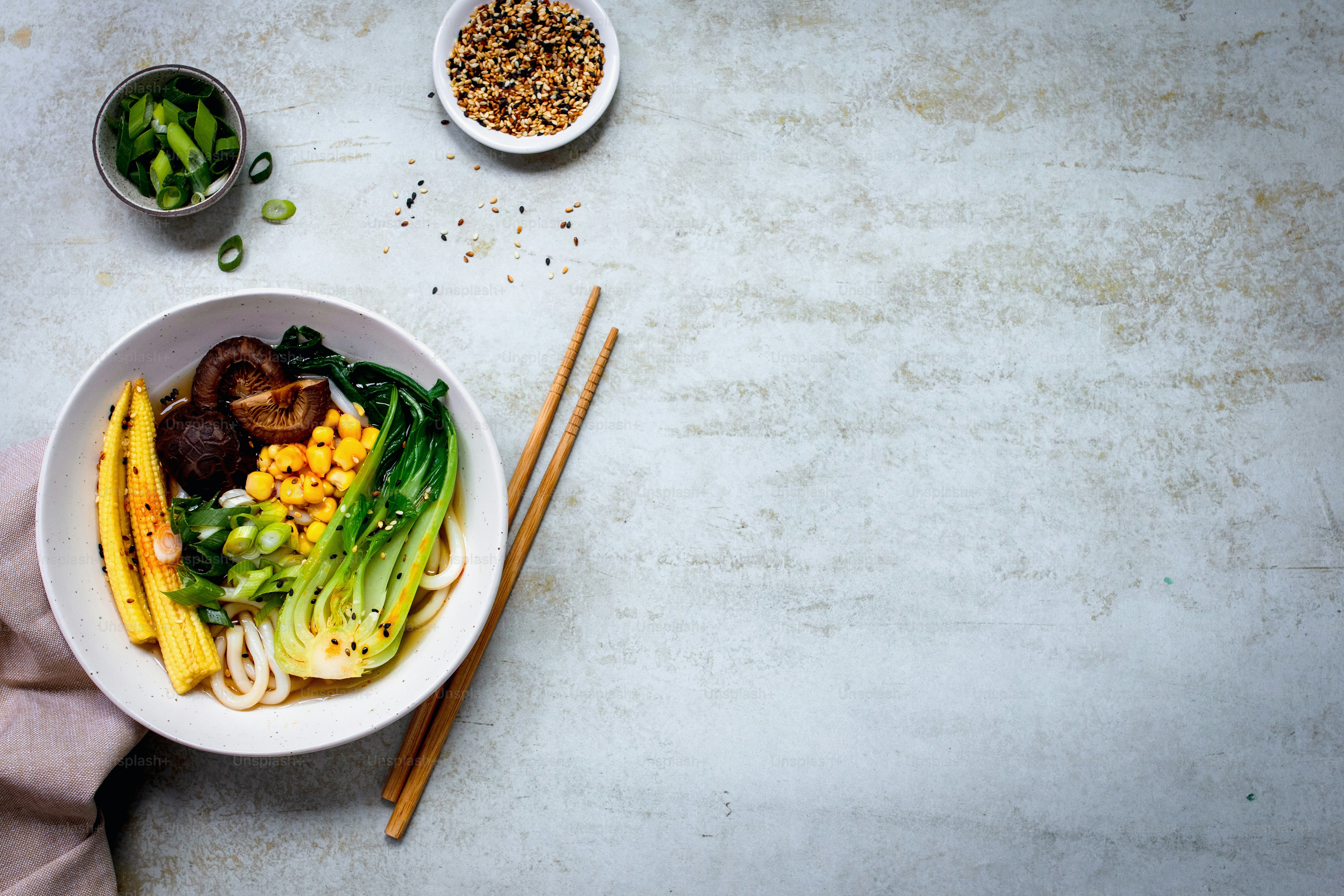 a bowl of food with chopsticks next to it