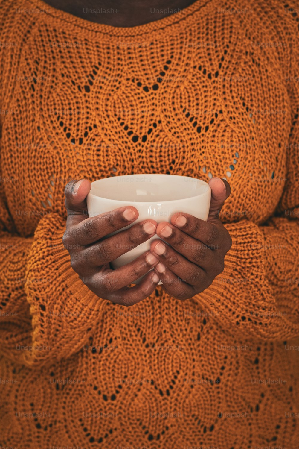 a woman holding a cup in her hands