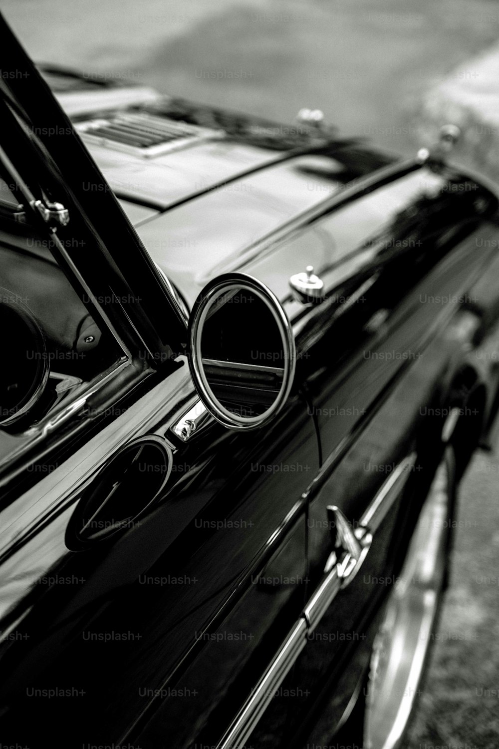 a black and white photo of a classic car