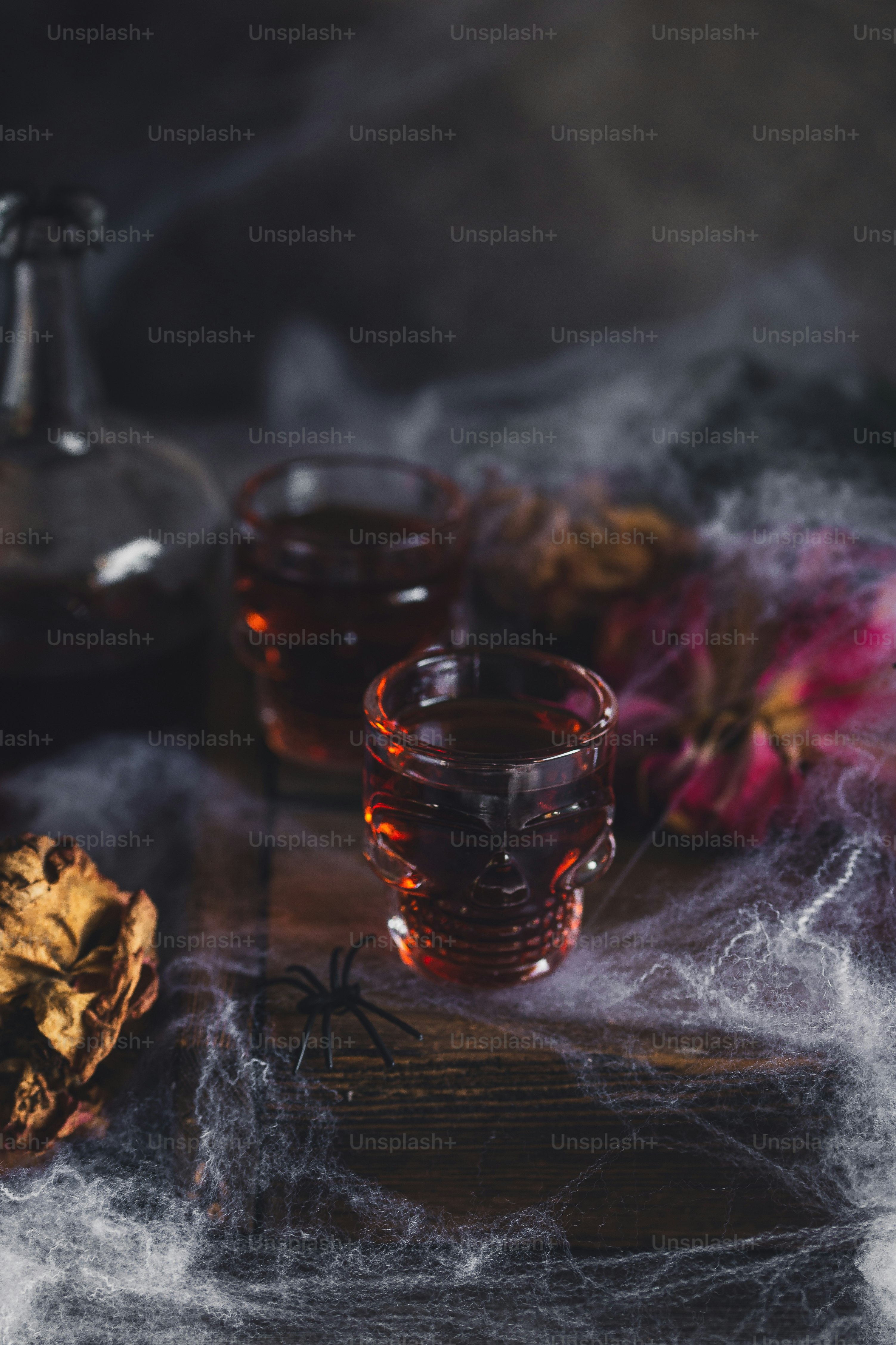 a glass of booze next to a bottle of booze