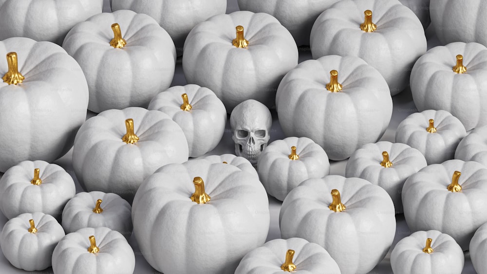 a group of white pumpkins with gold decorations on them