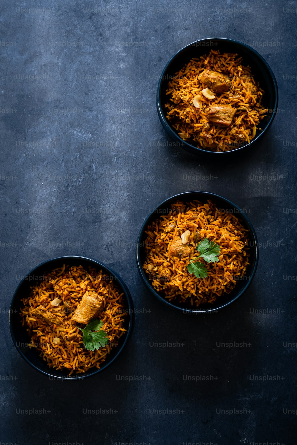 three bowls of food on a table