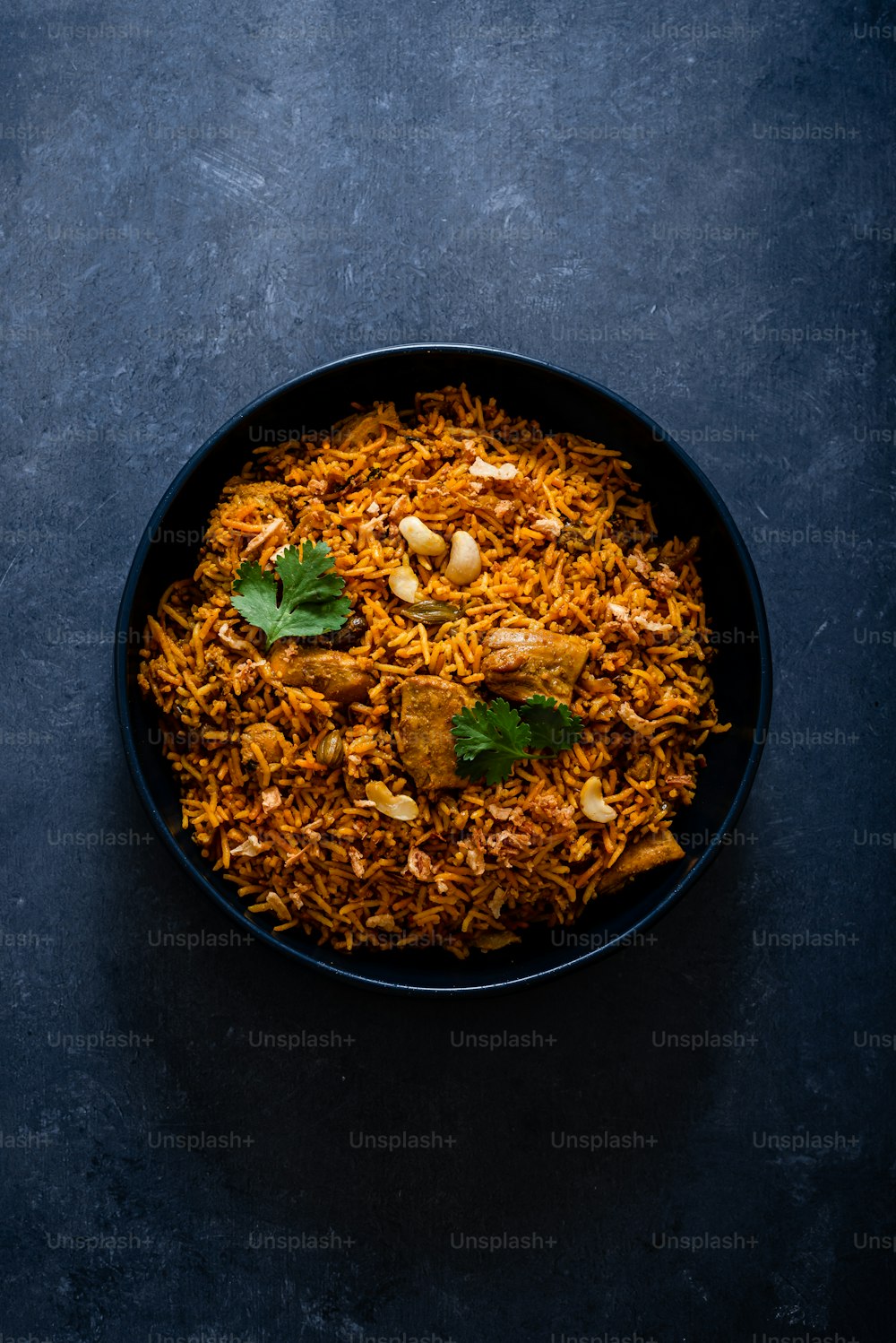 a black bowl filled with food on top of a table