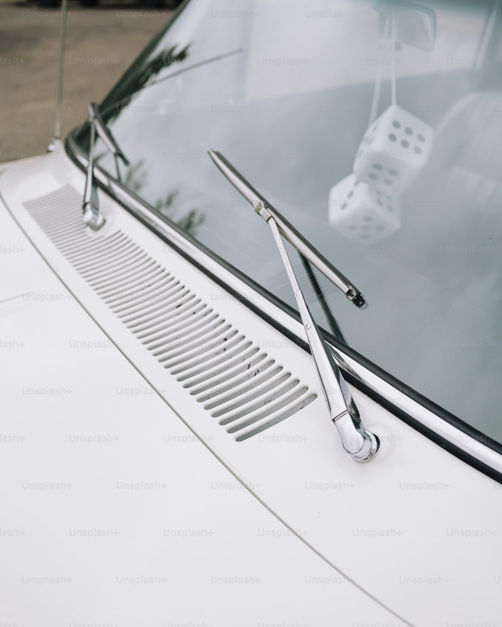 a close up of a white car with a pair of scissors on it