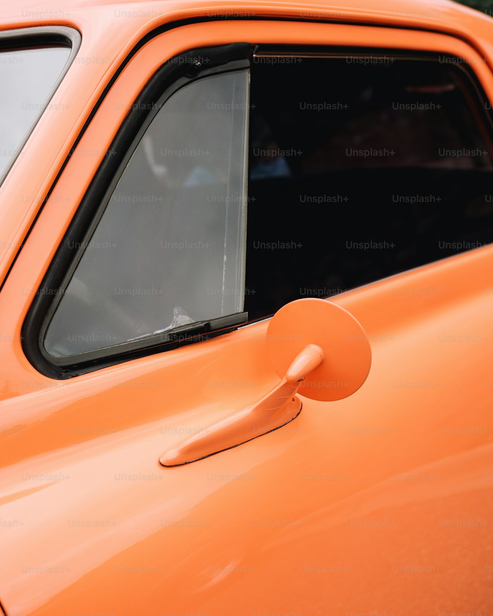 a close up of an orange car door handle