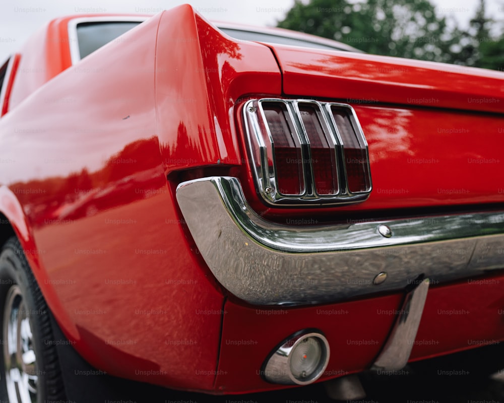 a close up of the tail end of a red mustang