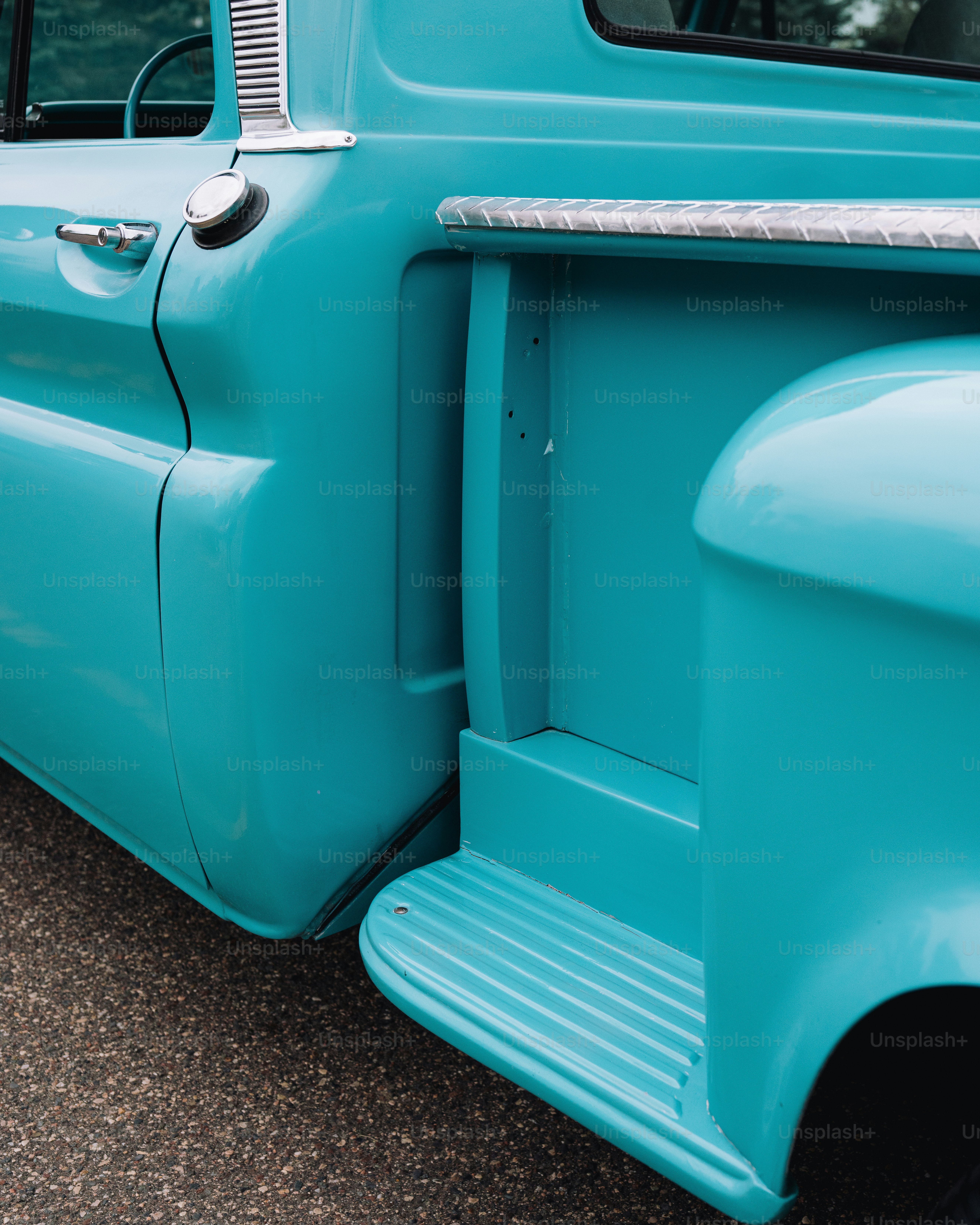 a close up of the front end of a blue truck