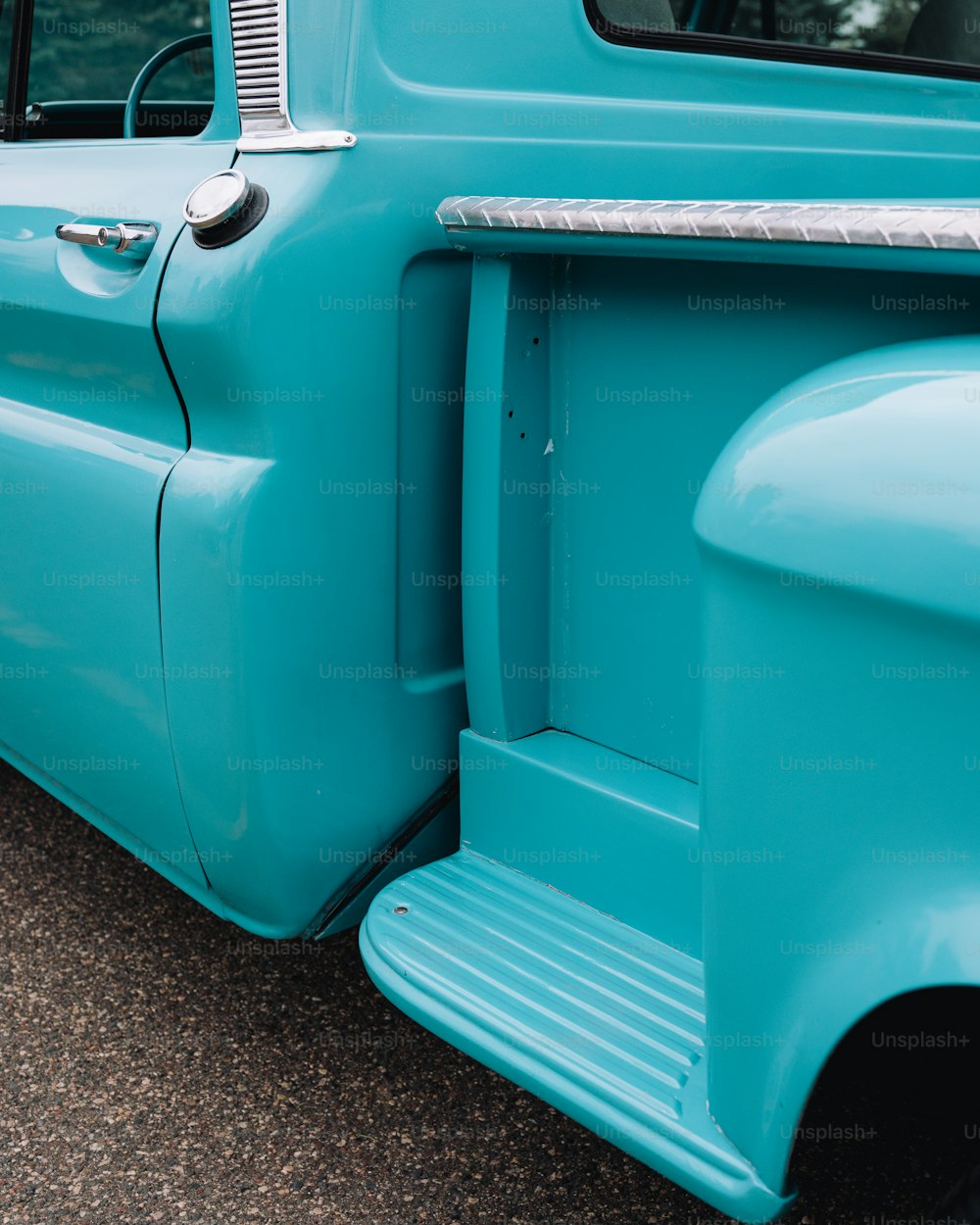 a close up of the front end of a blue truck