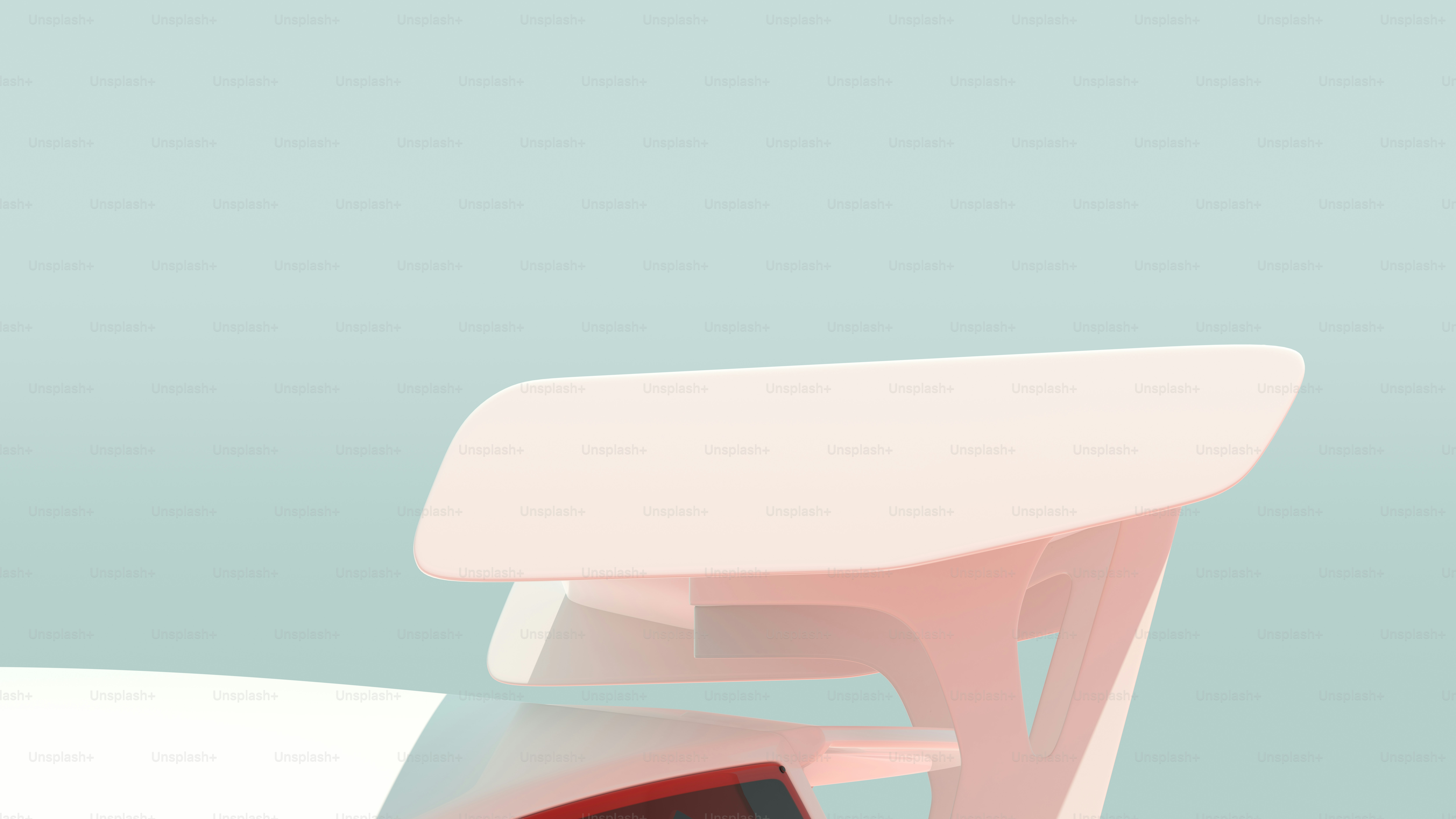 a white chair with a red seat and a white table