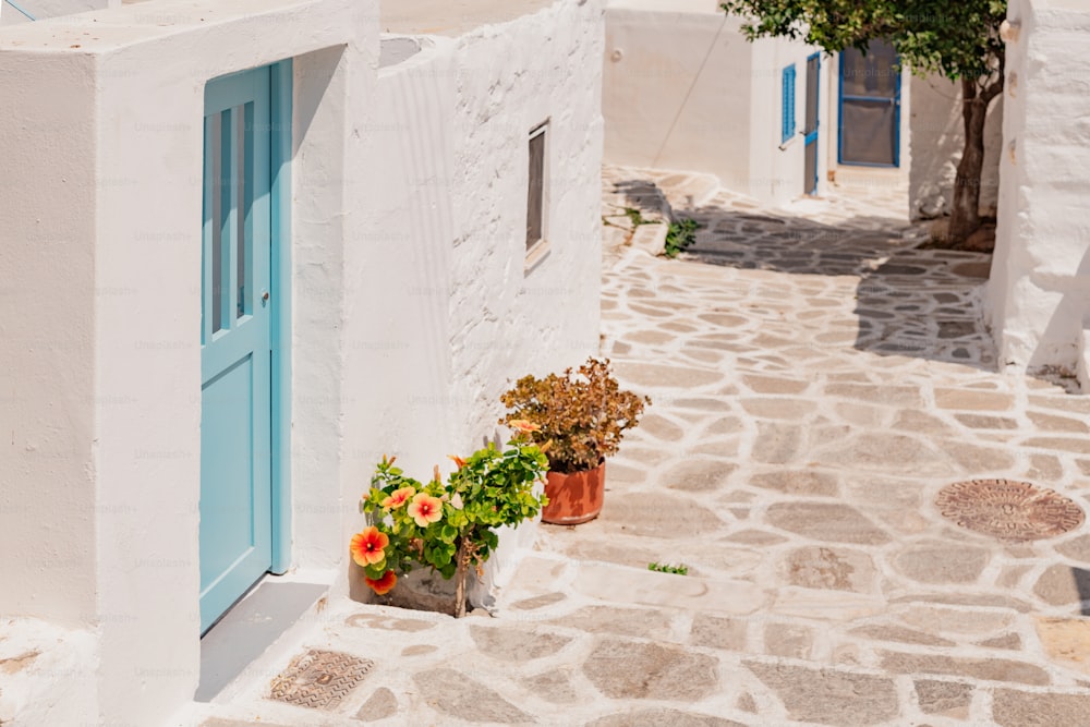 a small white building with a blue door and window