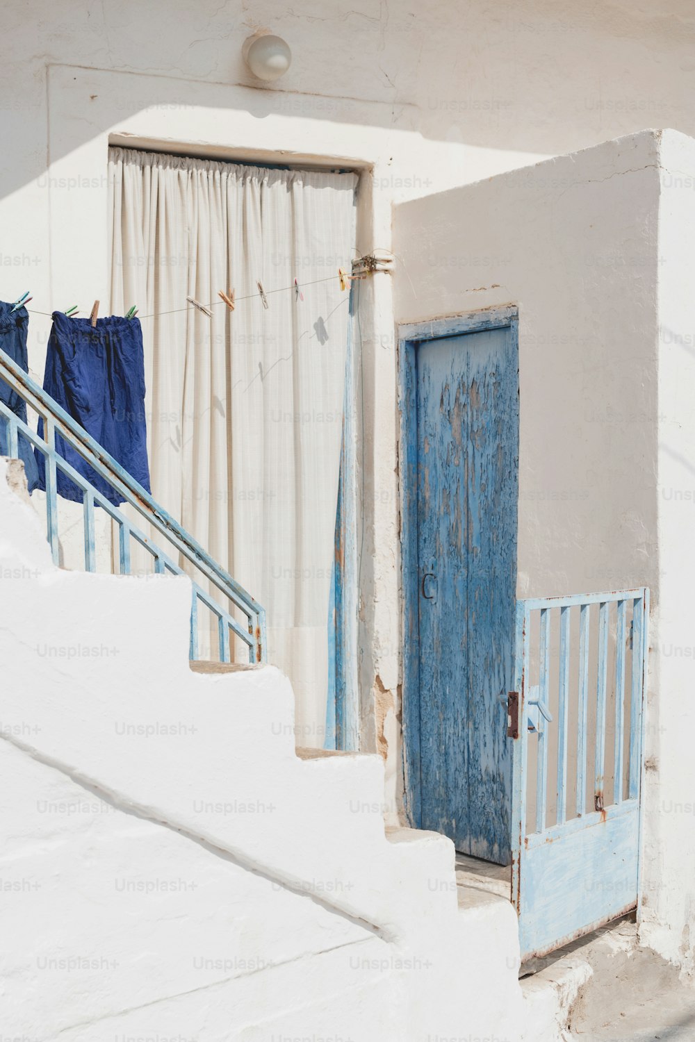 a blue door sitting next to a set of stairs