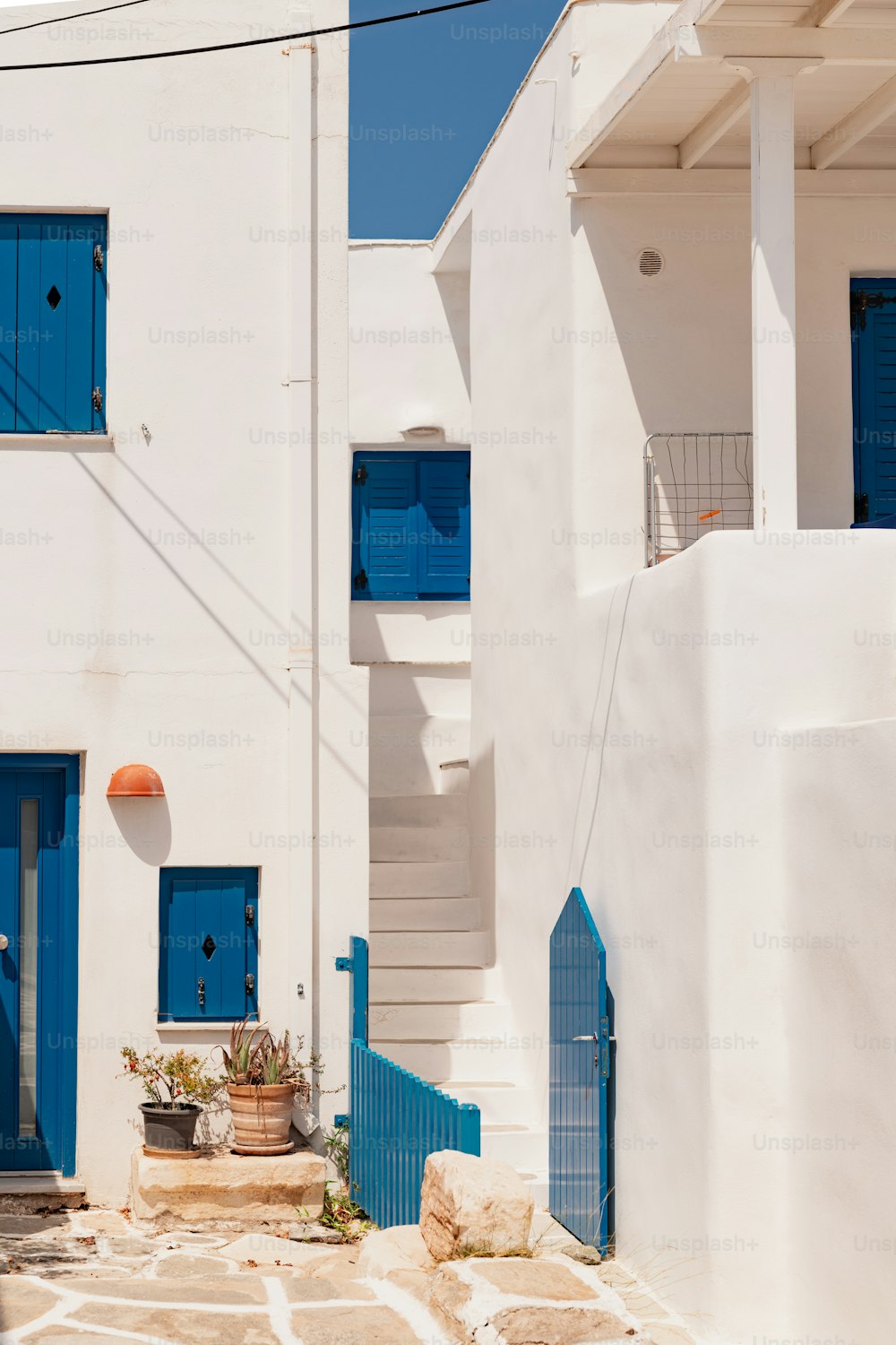 a couple of white buildings with blue doors