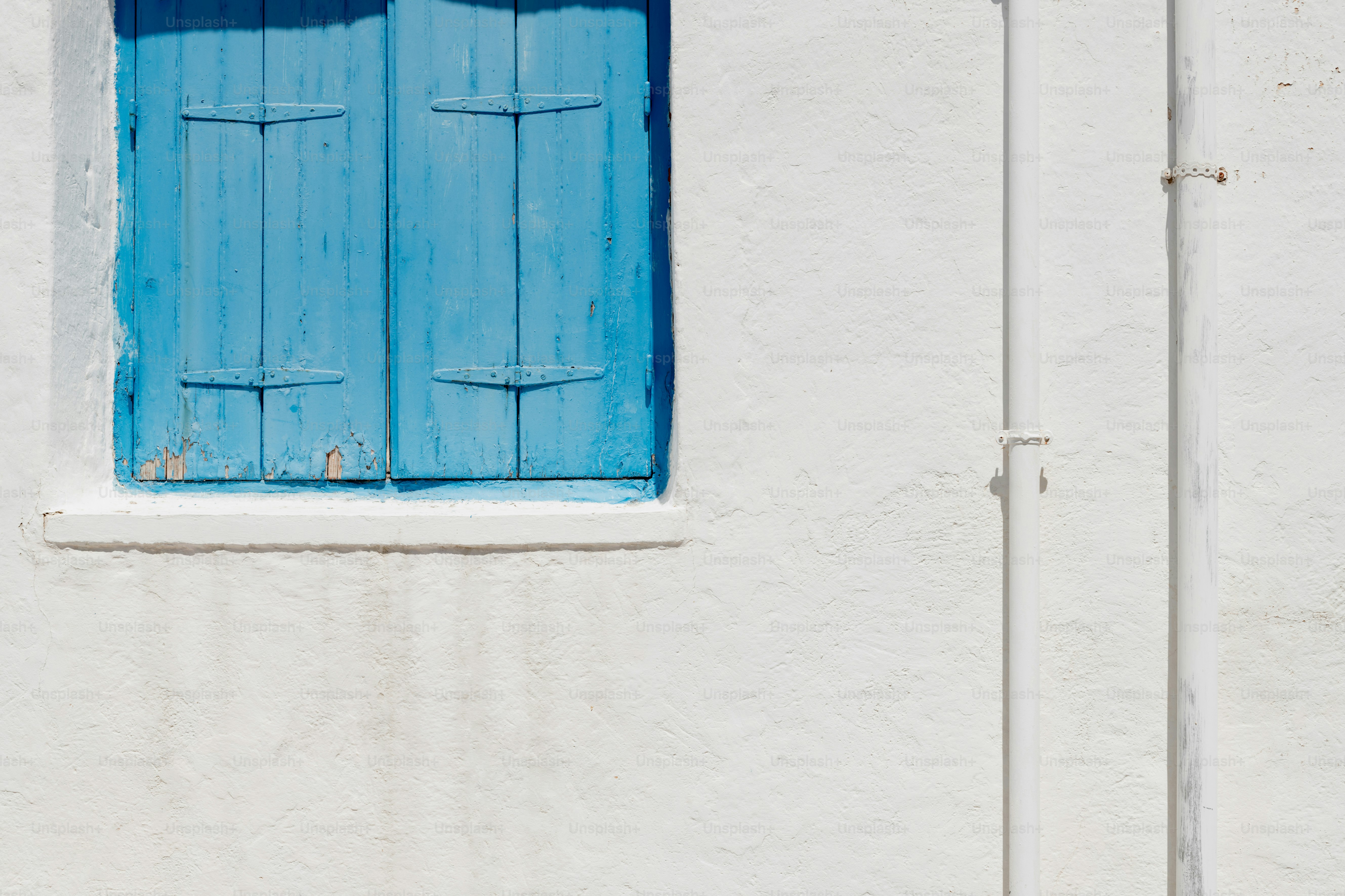 a white building with a blue door and window