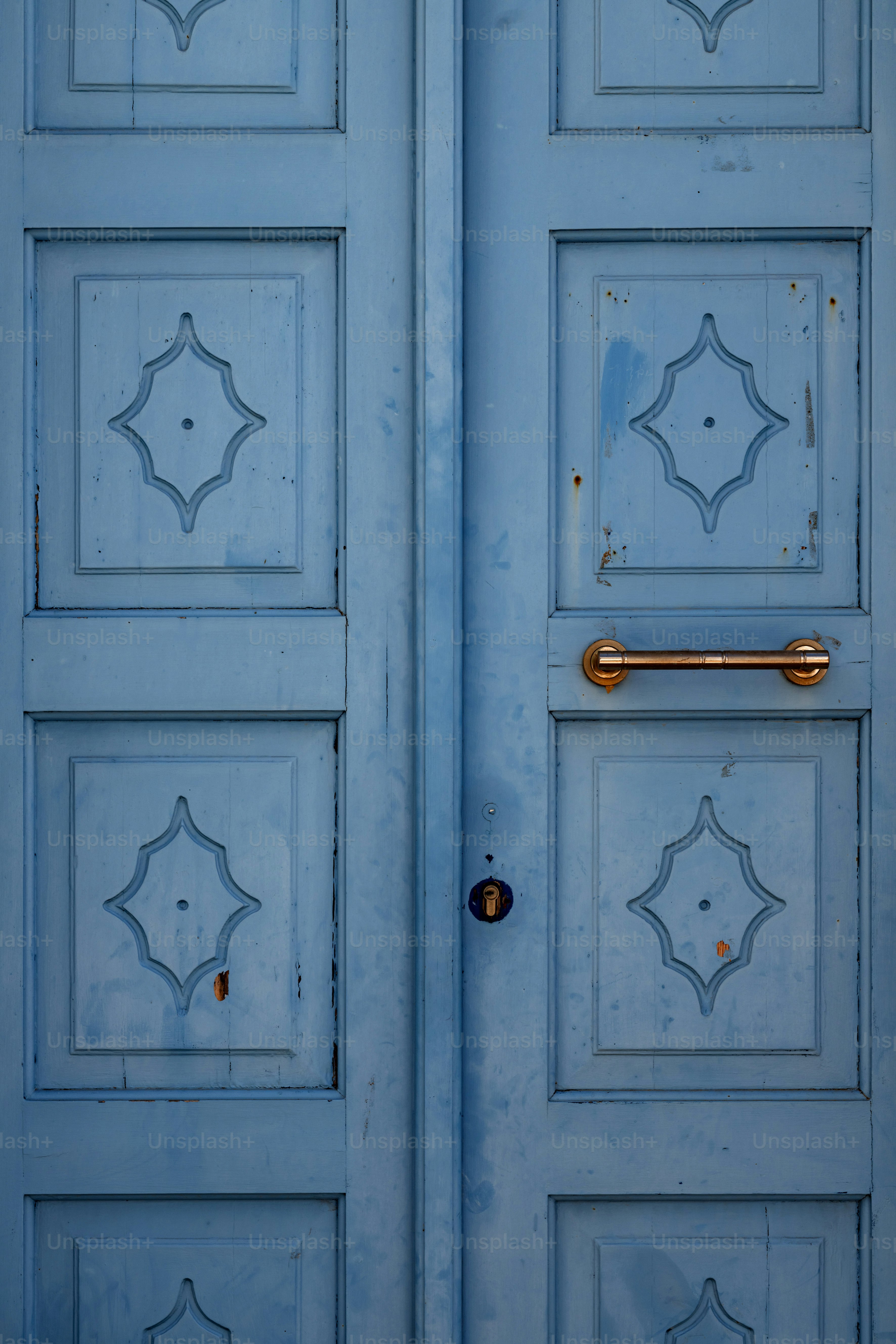 a close up of a blue door with a handle