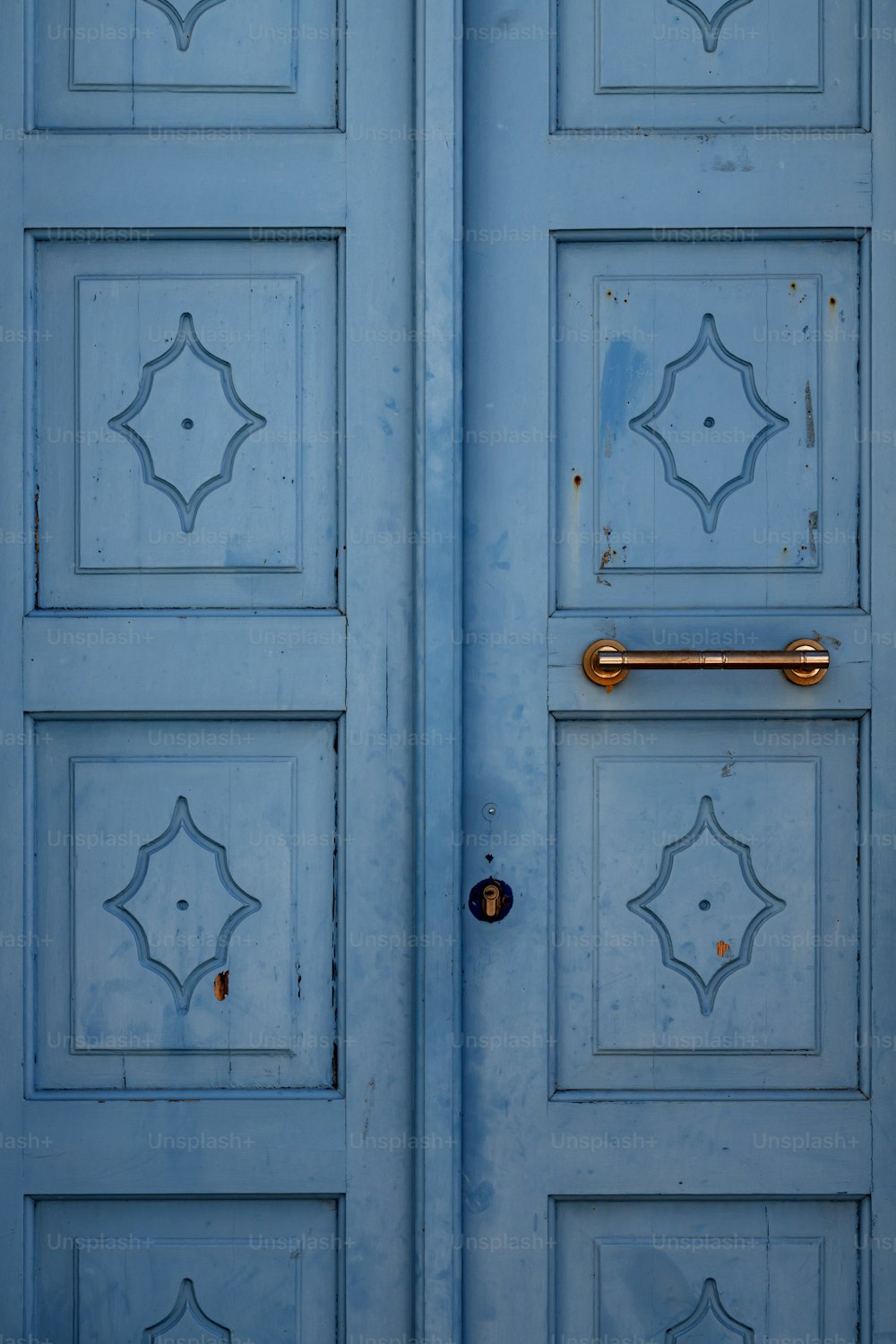 a close up of a blue door with a handle