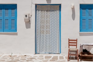 a chair and a table outside of a house