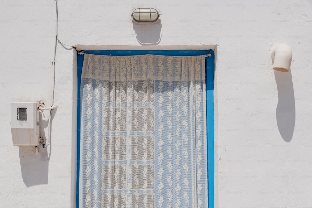 a window with a curtain hanging off of it's side
