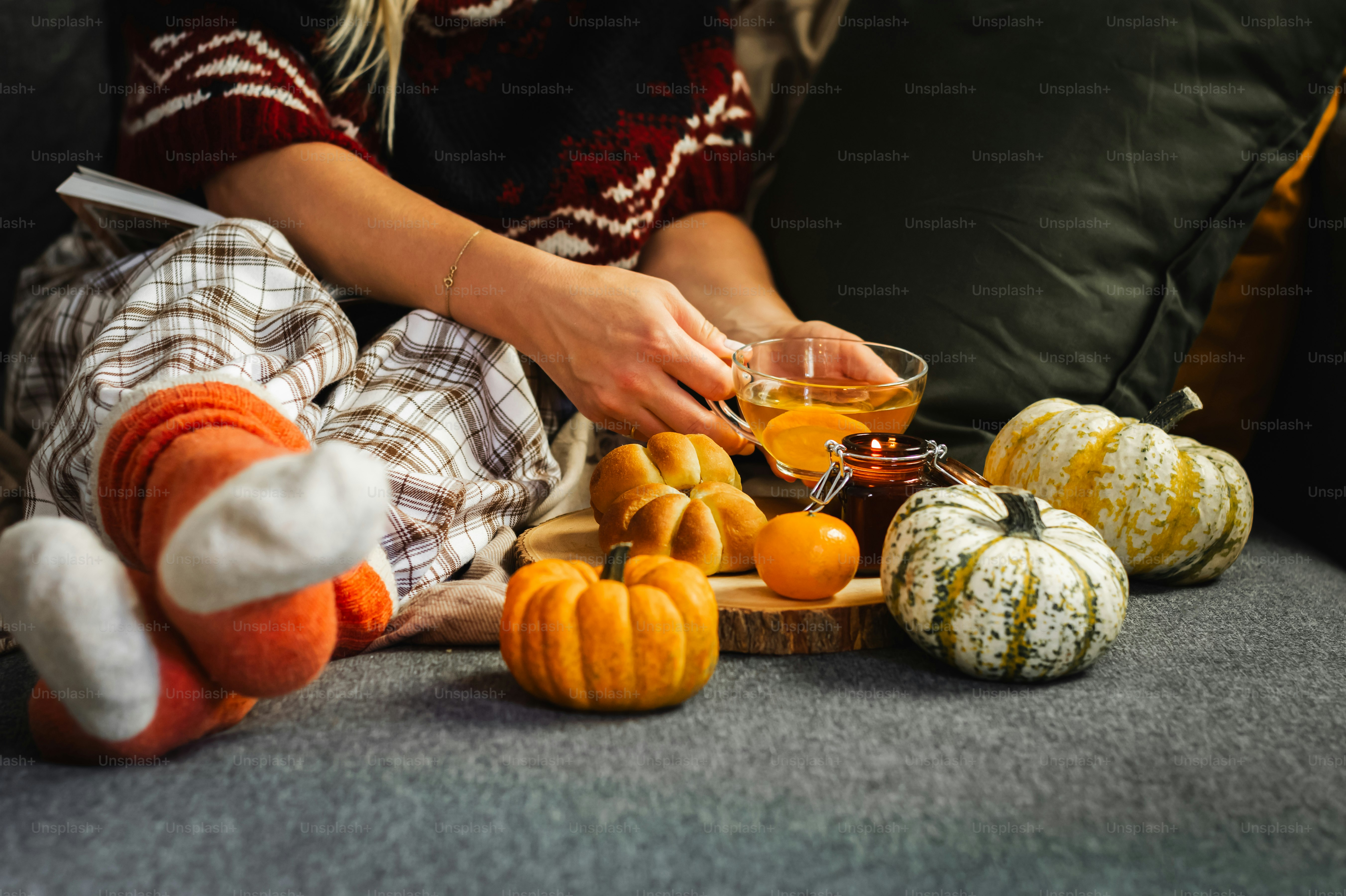 a woman sitting on a couch with a glass of orange juice