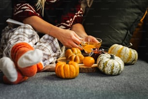 a woman sitting on a couch with a glass of orange juice