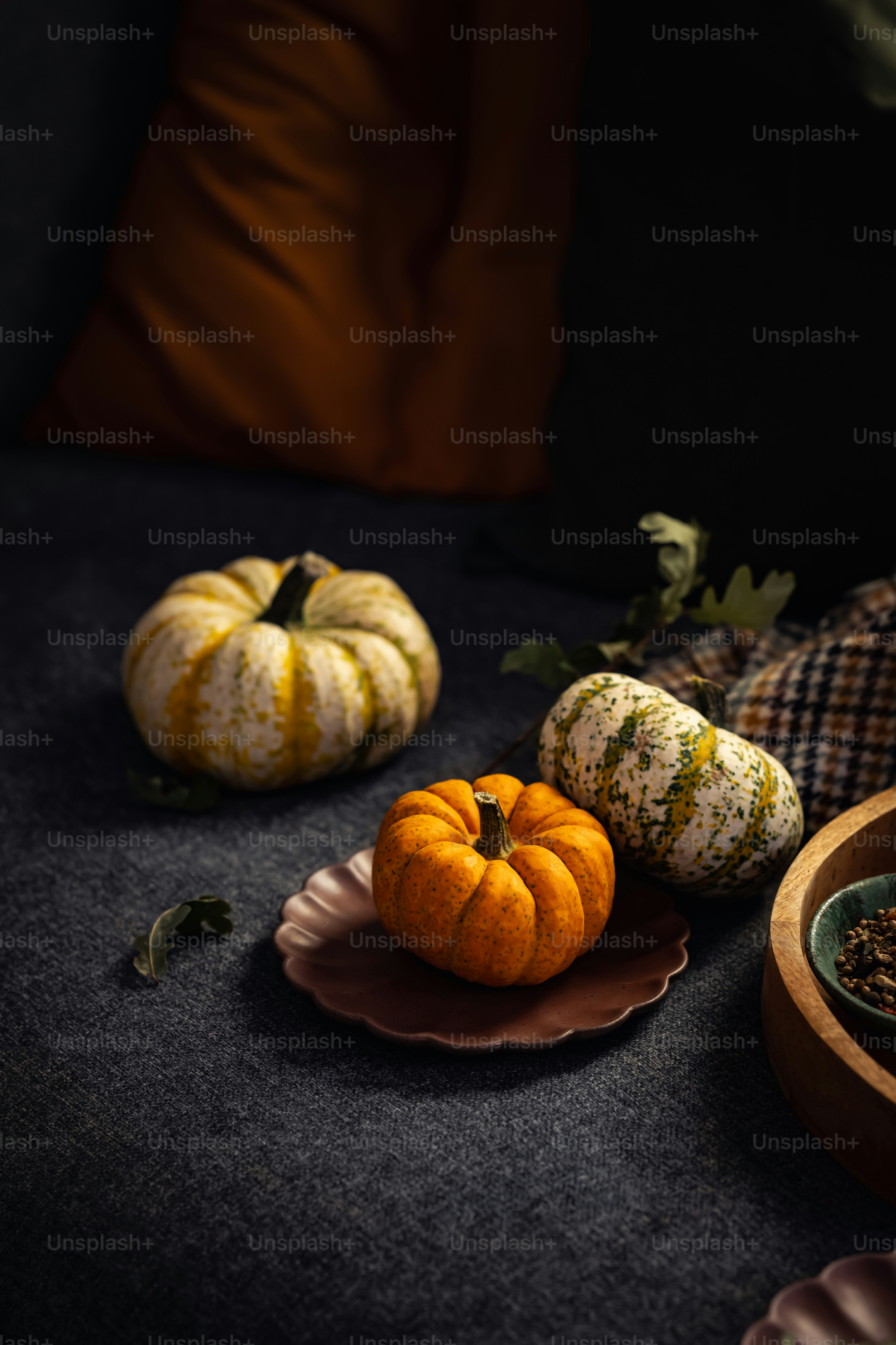 a couple of small pumpkins sitting on a table