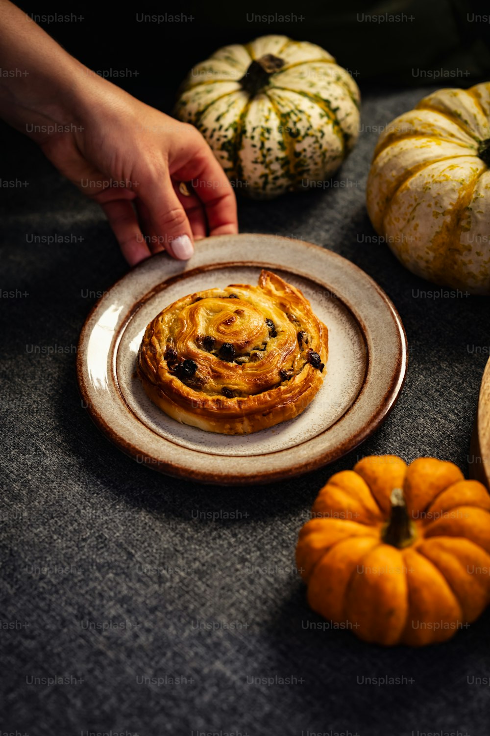 a plate of food on a table with pumpkins