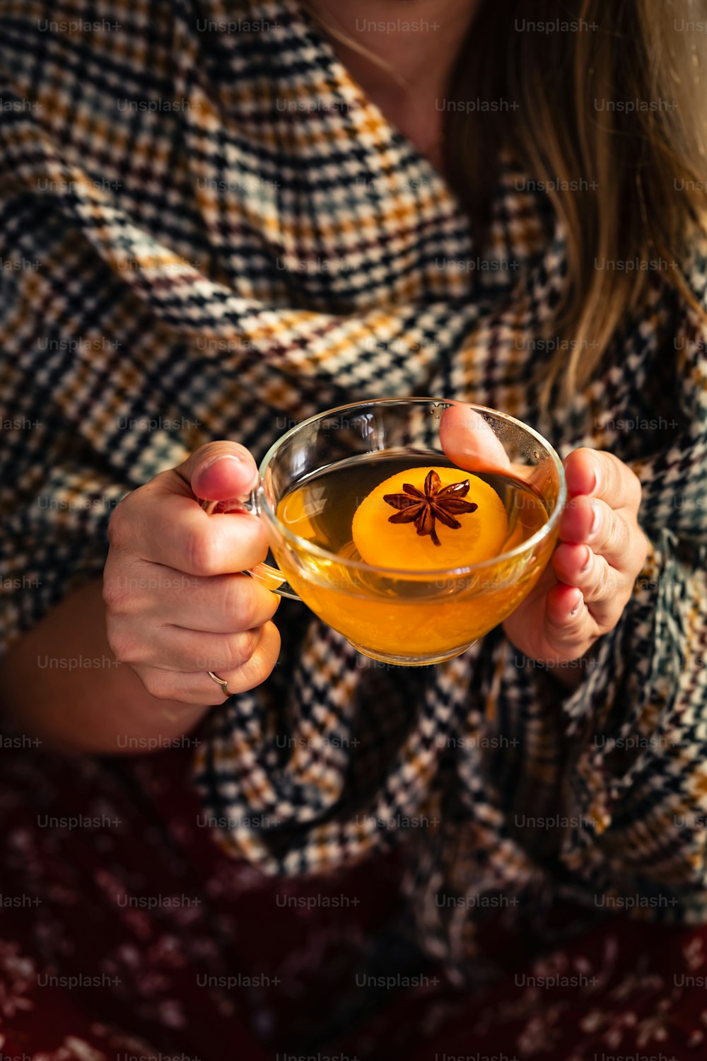 a woman is holding a glass of tea