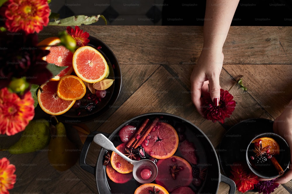 a table topped with a bowl of fruit and a bowl of flowers