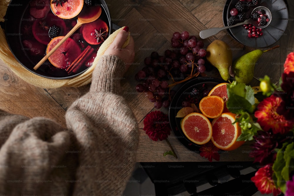 a table with a bowl of fruit and plates of fruit