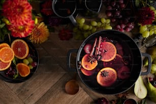 a table topped with a pot filled with fruit