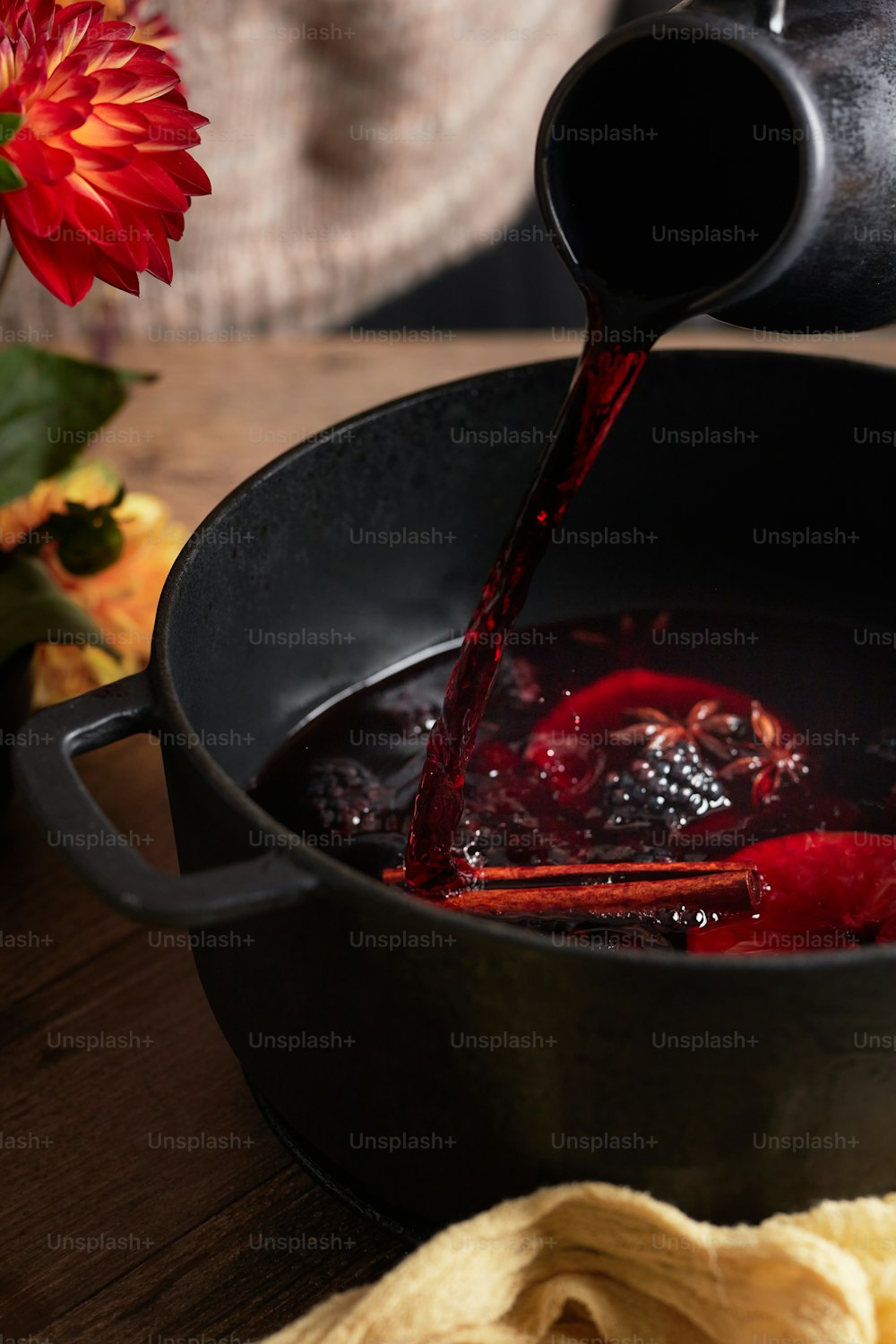 a pot filled with liquid being poured into it
