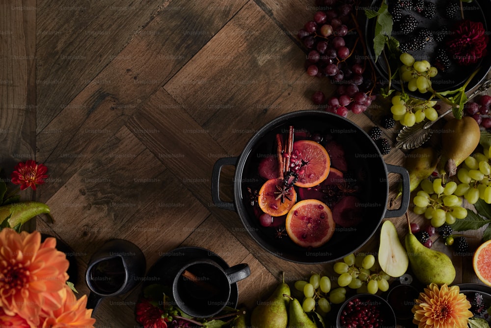 a wooden table topped with bowls of fruit